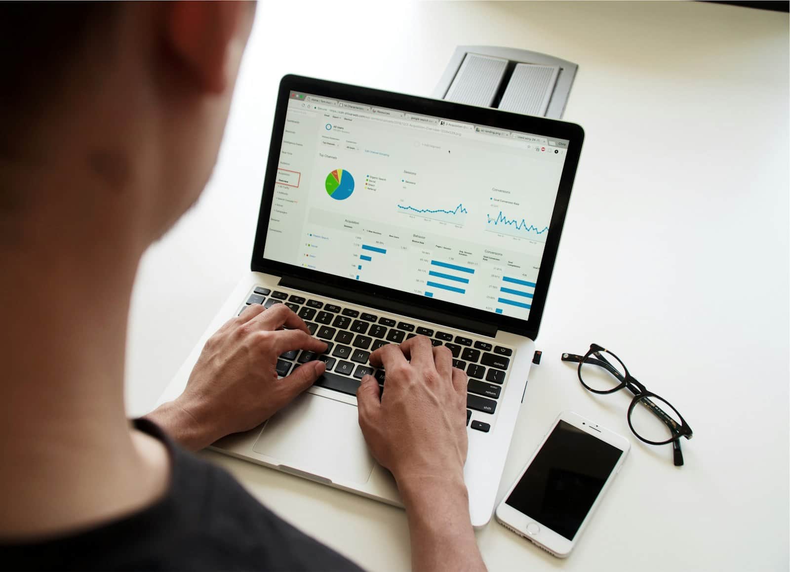 Person working on a laptop showing charts and reports